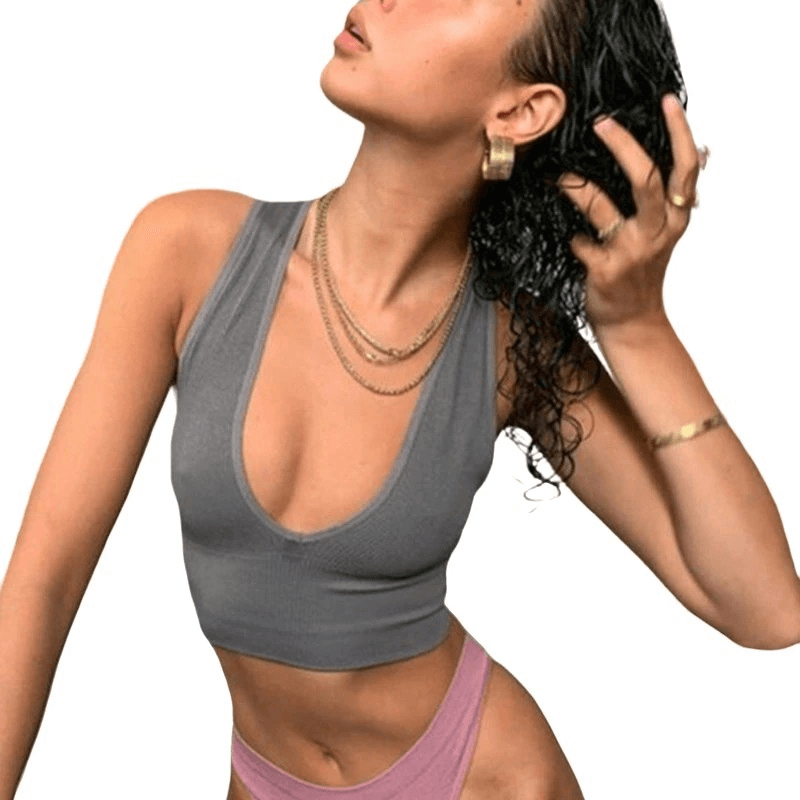 Model wearing a grey ribbed seamless tank top with deep V-neck, ideal for sport and yoga